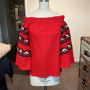 La Zuli red linen off-the-shoulder top with floral embroidery on sleeves